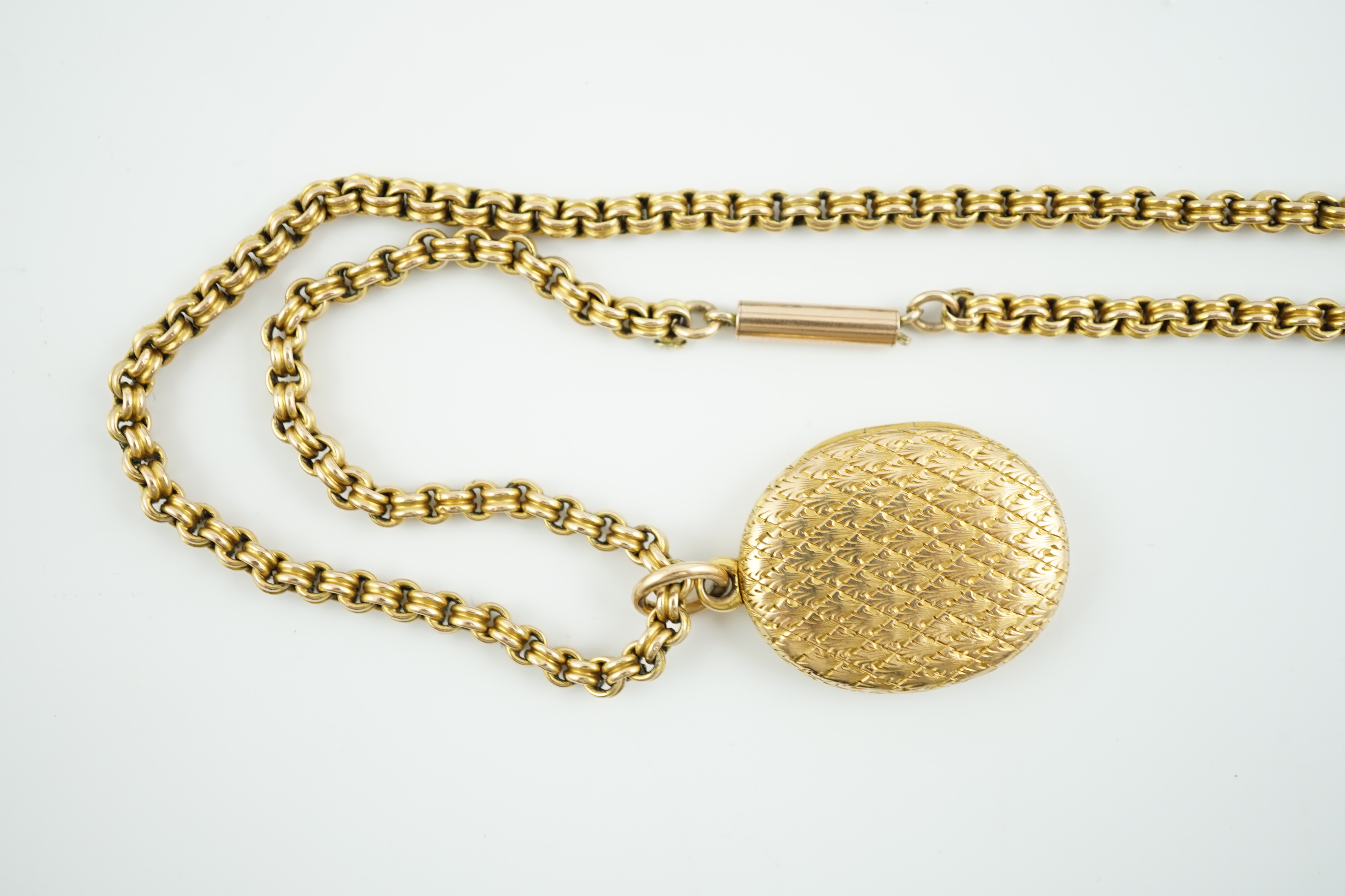 A late Victorian engraved gold oval locket, on a 10k chain